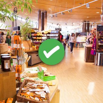 Eden Project shop with overlaid green tick